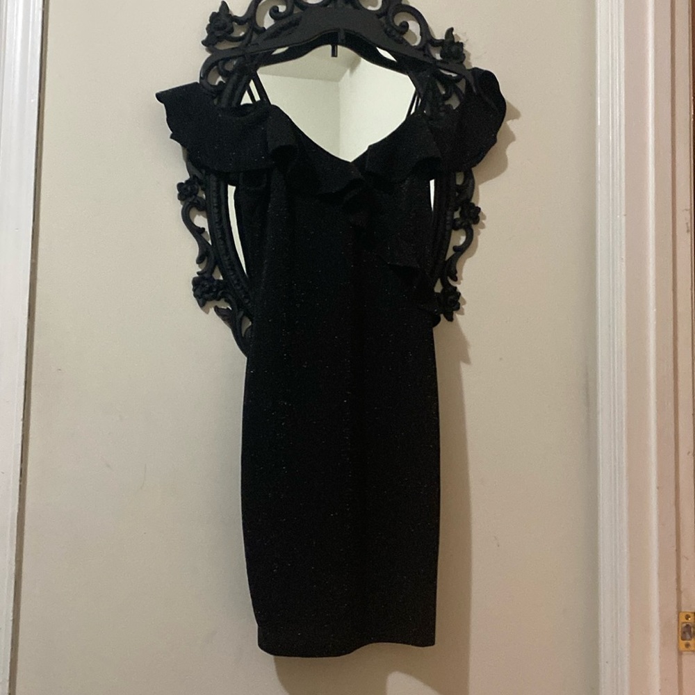 Beautiful mini black dress with sparkles of sequins .